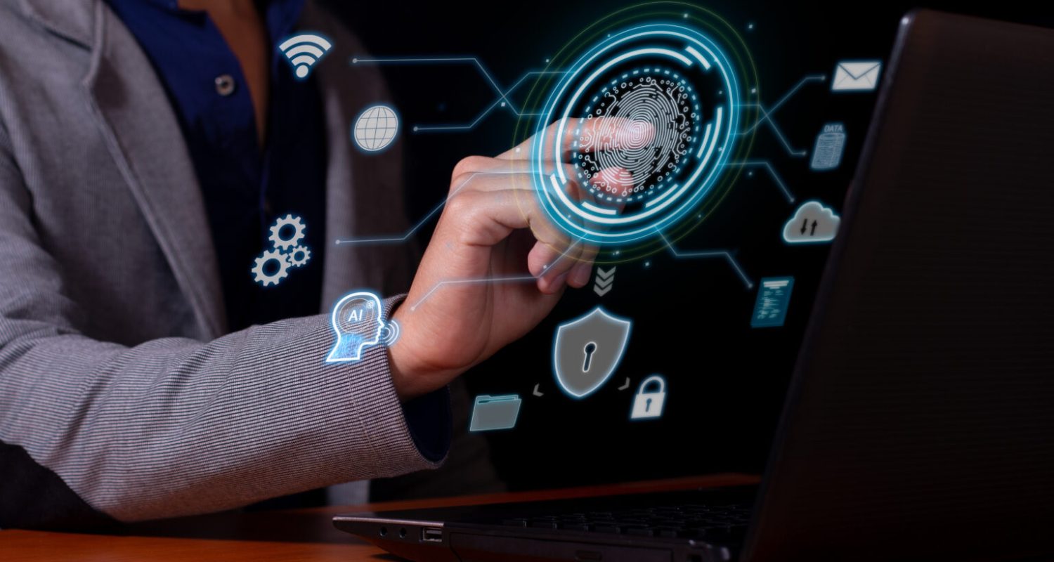 A man using cybersecurity biometrics to access his data, software and workspace.